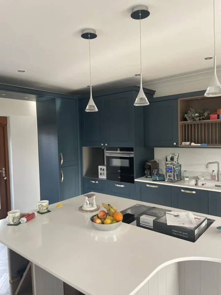 A newly painted and decorated kitchen area, coloured dark blue