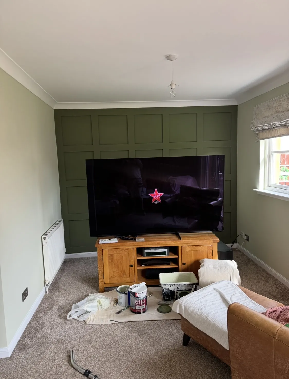 Small Livingroom with an accent wall that is painted dark green